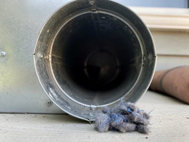 Bedford Dryer Vent Cleaning technician using specialized equipment to clear severe dryer vent blockage in Bedford